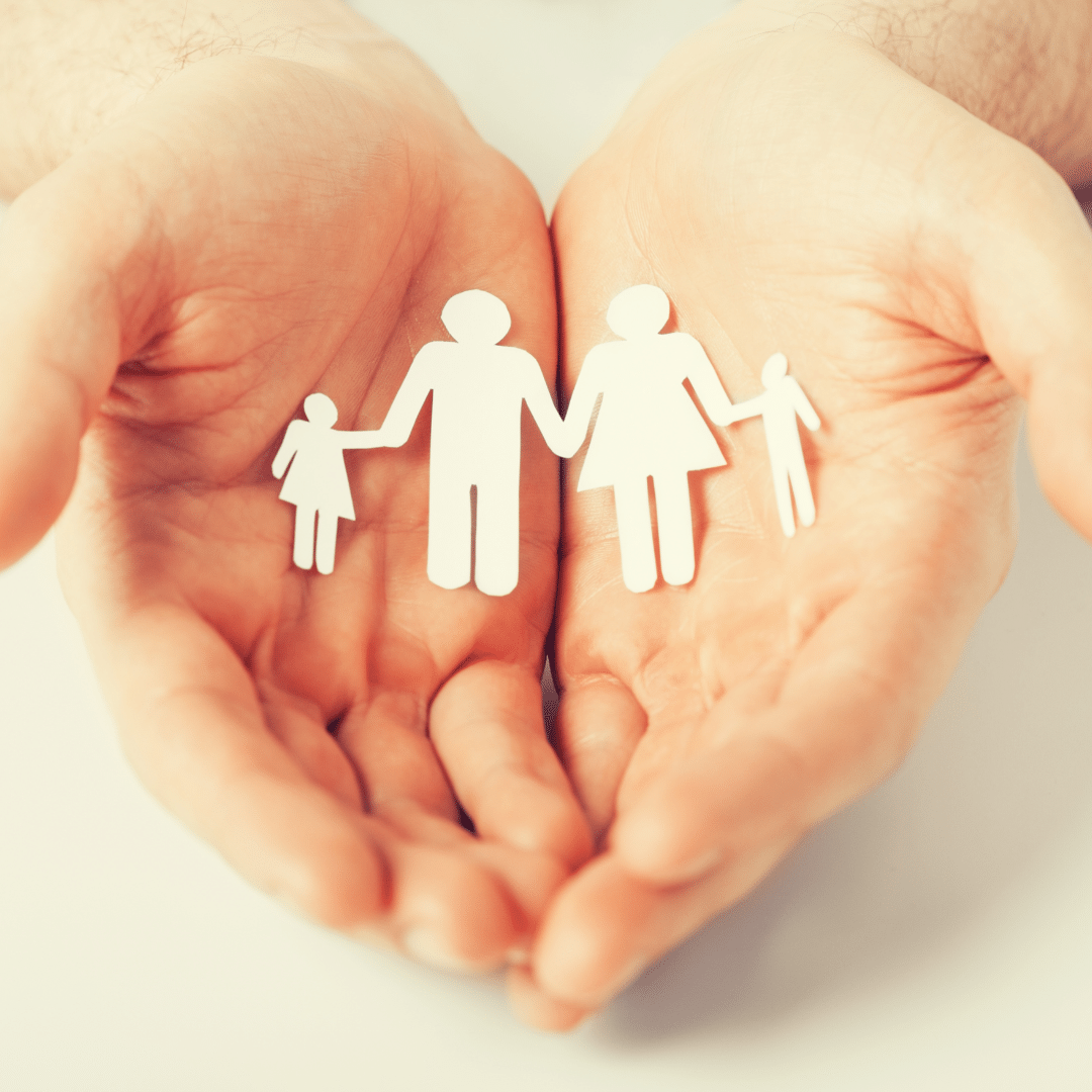 Hands holding paper family